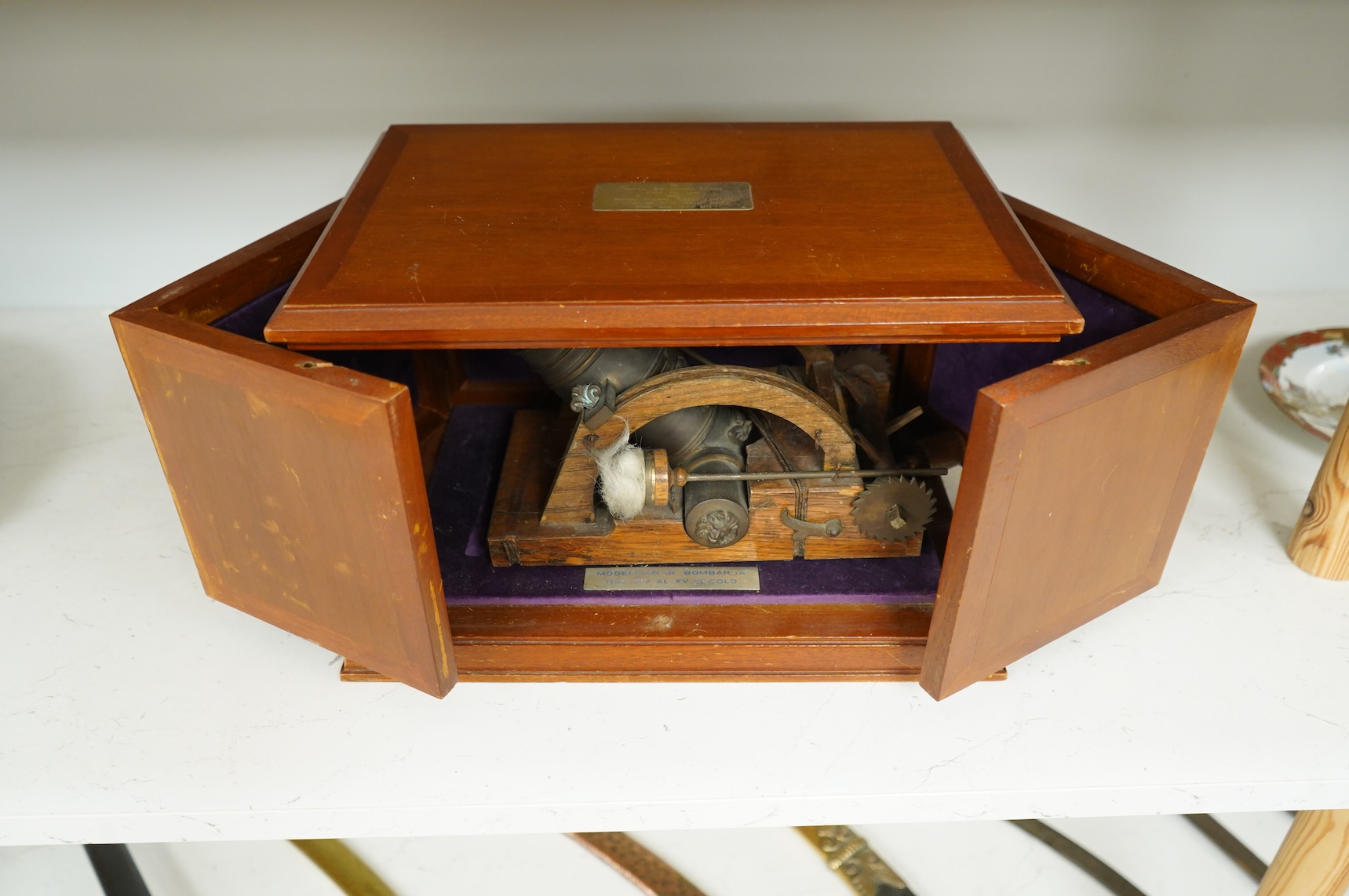 A teak cased presentation model of a bombarda mortar cannon in an oak frame, presented to Admiral Sir Michael Pollock from the Chief of Staff of the Italian Navy, with applied plaque to the lid engraved; ‘To Admiral Sir